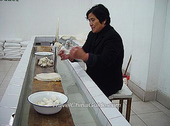 Drawing silk from cocoons