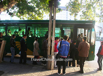 People queue up to get on the bus.