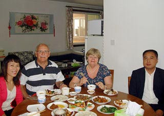 Mr. Gregory & Ms. Lynn Having a Meal in a Chinese Family