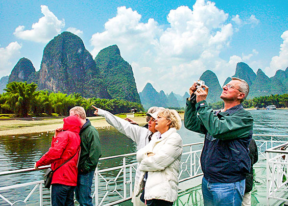 Appreciating Li River Landscape on Li River Cruise Ship